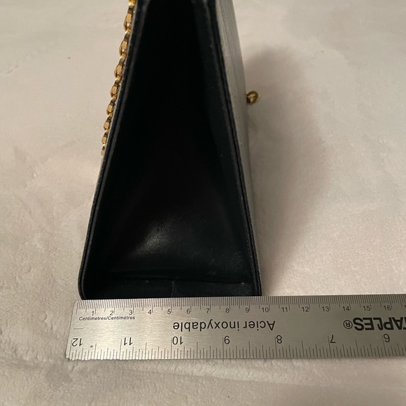 Authentic Salvatore Ferragamo black leather bag with shiny gold metal handle. - Picture 7 of 11